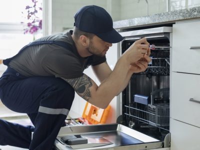 Technician Examining Dishwasher